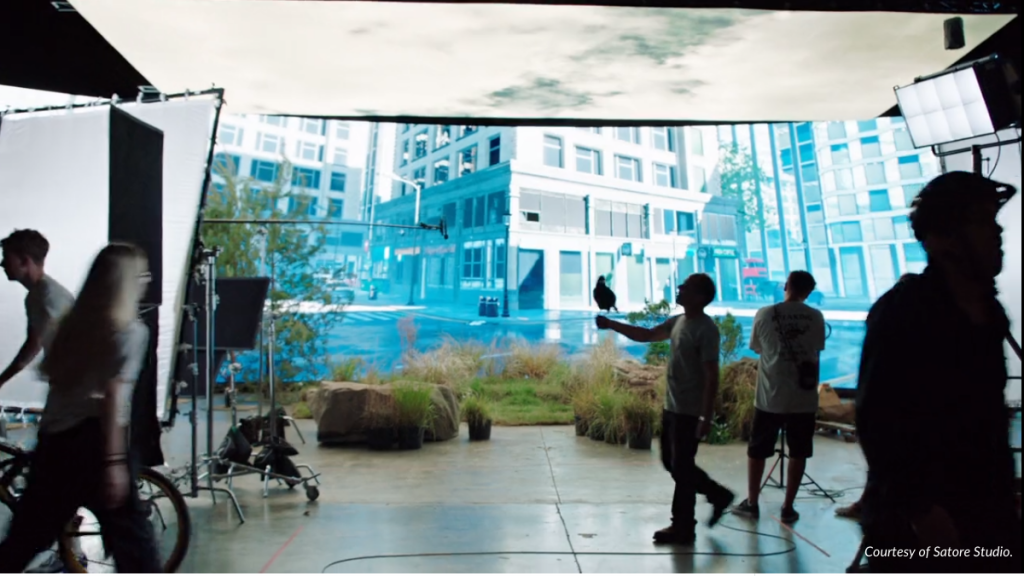 On set of a virtual production with a city street projected on an LED volume.